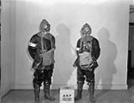 Personnel of the Royal Canadian Navy Air Raid Precaution (ARP) squad wearing anti-gas clothing, Halifax, Nova Scotia, Canada, 4 November 1942. November 4, 1942.