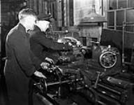 Electrical Artificers operating a lathe in the Electrical Artificers¿ Workshop, H.M.C. Dockyard, Halifax, Nova Scotia, Canada, 18 November 1942. November 18, 1942.