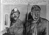 Mine disaster survivors Bill Miller (left) and Don Ferguson in change house after coming up from mine. 24 October 1958