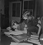 Children's Art Classes, Lismer's, two girls reading a book. [between 1939-1951].