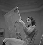 Children's Art Classes, Lismer's, girl holding up a canvas. [between 1939-1951].