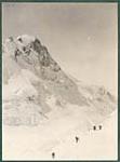 Working a way up through the ice wall above King Col. King Peak towering above [Graphic material] 1925.