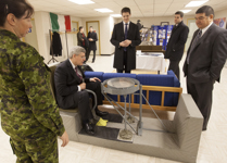 [Prime Minister Stephen Harper sits in a helicopter simulator during a tour of the military museum at 5 Wing Goose Bay following an event in Happy Valley-Goose Bay, Newfoundland] 30 November 2012