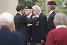 [French President Nicolas Sarkozy recognizes four veterans, one from each of the participating countries, at the Normandy American Cemetery, Omaha Beach in France] 6 June 2009