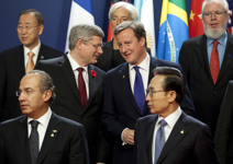[Prime Minister Stephen Harper speaks with British Prime Minister David Cameron during a family photo at the G20 Summit in Cannes, France] 3 November 2011
