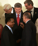 [Prime Minister Stephen Harper chats with French President Jacques Chirac during the family photo at the opening ceremony of the Francophonie Summit in Bucharest, Romania] 28 September 2006