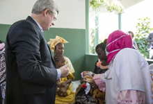 [Prime Minister Stephen Harper helps to administer the rotavirus vaccine to a young patient while at the Philippe Maguilen Senghor Health Clinic in Dakar, Senegal] 28 November 2014