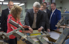 [Prime Minister Stephen Harper, Peter MacKay, Scott Armstrong, Jon Stanfield, President of Stanfield's North America, and Dan Clarke, Vice President Operations, tour the Stanfield's factory after announcing the new Canada 150 Community Infrastructure Program in Truro, Nova Scotia] 15 May 2015