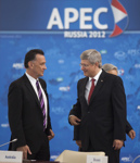 [Prime Minister Stephen Harper chats with Australia's Trade and Competitiveness Minister Craig Emerson in the APEC leaders' Retreat Session in Vladivostok, Russia] 7 September 2012