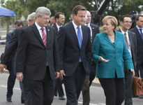 [Prime Minister Stephen Harper walks to the opening session with British Prime Minister David Cameron and German Chancellor Angela Merkel at the G8 Summit in Deauville, France] 26 May 2011
