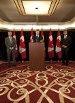 [Prime Minister Stephen Harper is joined by Lawrence Cannon, Minister of Foreign Affairs, and Gary Doer, Canada's Ambassador to the United States, as he announces a nuclear cooperation agreement with the United States in Washington, DC] 12 April 2010