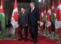 [King Abdullah of Jordan and Prime Minister Stephen Harper walk down the Hall of Honour for a news conference following their meeting on Parliament Hill in Ottawa] 13 July 2007