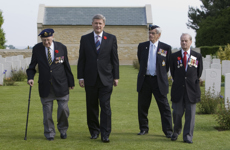 [Prime Minister Stephen Harper walks through the Canadian military cemetery in Beny-sur-Mer, France, with participants of the Memory Project] 6 June 2009