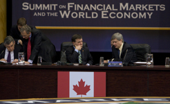 [Prime Minister Stephen Harper chats with Finance Minister Jim Flaherty during a plenary session at the G20 Summit on Financial Markets and the World Economy at the National Building Museum in Washington] 15 November 2008