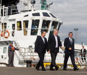 [Prime Minister Stephen Harper and Denis Lebel are greeted by Jean D'Amour upon their arrival in Sept-Îles, Quebec] 14 October 2014