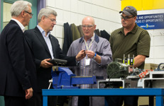 [Prime Minister Stephen Harper, joined by Greg Selinger, Premier of Manitoba, receives a demonstration in industrial mechanics by instructor Dan Zvanovec and student Wade Snow at the Manitoba Institute of Trades and Technology prior to announcing Oxygen Technical Services Limited as the first recipient of the Canada Job Grant in Winnipeg] 10 October 2014