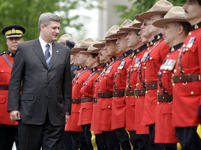 [Canadian Prime Minister Stephen Harper inspects troops during a ceremony honouring fallen RCMP officers in Ottawa] 23 May 2006