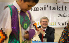 [Prime Minister Stephen Harper enjoys a dance performance during a feast with leaders of the Kainai Nation Blood Tribe in Standoff, Alberta] 7 February 2014