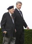 [Prime Minister Stephen Harper and D-Day veteran Phil LeBreton, 87, of Montréal walk through the Canadian military cemetery in Beny-sur-Mer, France] 6 June 2009