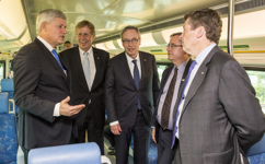 [Prime Minister Stephen Harper chats with Finance Minister Joe Oliver, Metrolinx President and CEO Bruce McCuaig, Metrolinx Chair Robert Prichard, and Toronto Mayor John Tory, while riding the Go Train prior to announcing further details regarding the new Public Transit Fund] 18 June 2015
