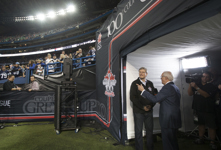 [Prime Minister Stephen Harper chats with TSN's Brian Williams prior to the start of the Grey Cup in Toronto] 25 November 2012