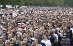 [A crowd of thousands listens as US President Barack Obama, British Prime Minister Gordon Brown, Canadian Prime Minister Stephen Harper, and French President Nicolas Sarkozy address them at the Normandy American Cemetery, Omaha Beach in France] 6 June 2009