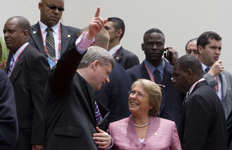 [Prime Minister Stephen Harper talks with Michelle Bachelet, the President of Chile, during a family photo at the Diplomatic Centre for the Summit of the Americas in Port of Spain, Trinidad and Tobago] 19 April 2009