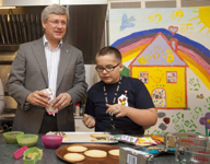 [Prime Minister Stephen Harper and his wife Laureen Harper bake cookies with Michelle and Braxton Wacholtz at Ronald McDonald House in Vancouver, British Columbia] 7 August 2012