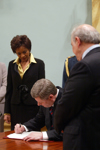 [Stephen Harper signs documents after he is sworn in as the 22nd Prime Minister of Canada at Rideau Hall in Ottawa, Ontario] 6 February 2006