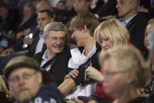 [Prime Minister Stephen Harper chats with his son Ben during the Grey Cup action in Toronto] 25 November 2012