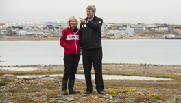 [Prime Minister Stephen Harper and his wife Laureen Harper pause for a photo with Cambridge Bay, Nunavut in the background] 23 August 2012