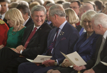 [Prime Minister Stephen Harper chats with His Royal Highness the Prince of Wales at a royal tour event at the RCMP Depot Division Drill Hall in Regina, Saskatchewan] 23 May 2012