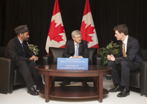[Prime Minister Stephen Harper and Dr. Andrew Bennett, Ambassador to the Office of Religious Freedom, sit down with Lal Khan Malik, National President of Ahmadiyya Muslim Jama'at Canada, prior to announcing the establishment of the Office of Religious Freedom in Vaughan, Ontario] 19 February 2013