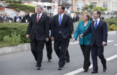[Prime Minister Stephen Harper walks to the opening session with British Prime Minister David Cameron, German Chancellor Angela Merkel and Russian President Dmitry Medvedev at the G8 Summit in Deauville, France] 26 May 2011
