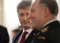 [Prime Minister Stephen Harper chats with Chief of Defense Staff Walter Natynczyk at an emergency meeting on the crisis in Libya in Paris, France] 19 March 2011