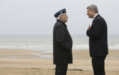 [D-Day veteran Sam Garnet, 85, of Montréal and Prime Minister Stephen Harper chat as they walk on Juno Beach following the 65th D-Day ceremony in Courseulles-sur-Mer, France] 6 June 2009
