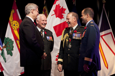[Prime Minister Stephen Harper and David Johnston, Governor General of Canada, chat with General Walter Natynczyk, former Chief of Defence Staff, and the newly appointed General Tom Lawson, Chief of Defence Staff, at the Change of Command ceremony at the Canadian War Museum in Ottawa] 29 October 2012