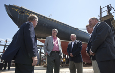 [Prime Minister Stephen Harper is joined by Gerald Keddy, Captain Wayne Walters, Peter Kinley, and Darrel Dexter, Premier of Nova Scotia, as he surveys the restoration work being done on the historic Bluenose II tall ship docked in Lunenburg, Nova Scotia] 18 August 2010