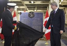 [Prime Minister Stephen Harper and Captain Harvey Durnford unveil a plaque stating the history behind the name of Marine Atlantic's newest ferry, the Blue Puttees in St. John's, Newfoundland] 11 February 2011