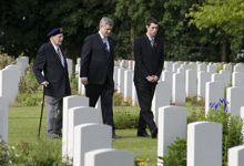 [Prime Minister Stephen Harper, D-Day veteran Phil LeBreton, 87, of Montréal and youth delegate Christopher Bernard, 17, of Gatineau, Quebec, walk through the Canadian military cemetery in Beny-sur-Mer, France] 6 June 2009