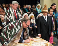 [Prime Minister Stephen Harper participates in a paddle signing ceremony with Bernard Valcourt, Minister of Aboriginal Affairs and Northern Development, and Shawn Atleo, National Chief of the Assembly of First Nations in Canada, in Standoff, Alberta] 7 February 2014