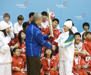 [Prime Minister Stephen Harper and his wife Laureen Harper visit the Canadian International School of Beijing and are greeted by torchbearers Ms. Ye Qiaobo and Ms. Yang Yang] 3 December 2009