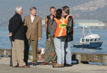 [Prime Minister Stephen Harper, British Columbia Premier Gordon Campbell and Minister Ray Emerson chat with port staff after making an announcement on Canada's Asia-Pacific Gateway and Corridor Initiative in Vancouver, British Columbia] 11 October 2006