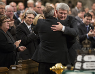 [Prime Minister Stephen Harper hugs Tom Mulclair after delivering remarks in the House of Commons addressing the attacks in the nation's capital] 23 October 2014