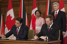[Prime Minister Stephen Harper and Kamla Persad-Bissessar, Prime Minister of the Republic of Trinidad and Tobago, look on as Peter MacKay shakes hands with His Excellency Philip Buxo, High Commissioner for the Republic of Trinidad and Tobago to Canada, during a signing ceremony in Ottawa, Ontario] 25 April 2013