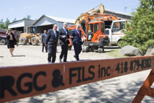 [Prime Minister Stephen Harper, joined by Denis Lebel and Philippe Couillard, Premier of Quebec, tours Rock Guay Contracteur inc. after announcing the renewal of the Gas Tax Fund Administrative Agreement with Quebec, while in Roberval, Quebec] 25 June 2014