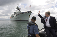 [Prime Minister Stephen Harper sits on the bow of a rigid-hulled inflatable boat (RHIB) on his way to visit the HMCS Ville de Quebec while at the Commonwealth Heads of Government Meeting in Trinidad and Tobago] 29 November 2009