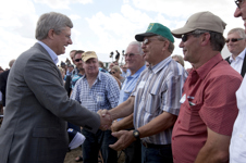 [Prime Minister Stephen Harper shakes hands with farmers on Grain Marketing Freedom Day in Kindersley, Saskatchewan] 1 August 2012