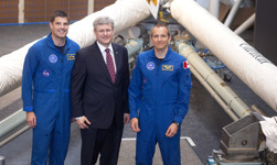 [Prime Minister Stephen Harper poses for a photo with astronauts Jeremy Hansen and David Saint-Jacques in front of the Canadarm at the Canada Aviation and Space Museum in Ottawa] 15 March 2013