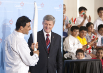 [Prime Minister Stephen Harper hands Bollywood star and 2010 Olympic Torch-bearer Akshay Kumar an Olympic Torch during a Canadian Tourism Event in Mumbai, India] 16 November 2009